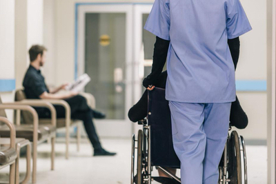nurse pushing wheelchair med